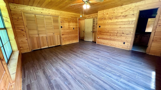 201 Cemetery Rd, Boyd, TX 76023 - unfurnished bedroom with dark wood-style flooring, wood ceiling, wooden walls, ensuite bath, and ceiling fan