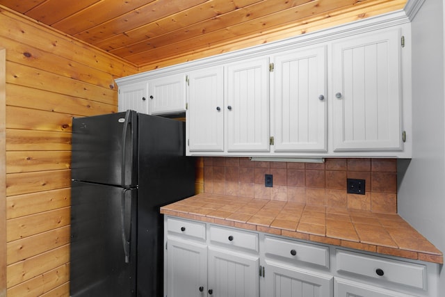201 Cemetery Rd, Boyd, TX 76023 - kitchen with freestanding refrigerator, decorative backsplash, white cabinets, tile countertops, and wooden ceiling