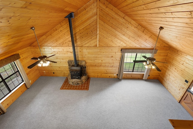 201 Cemetery Rd, Boyd, TX 76023 - unfurnished living room with a ceiling fan, wood ceiling, plenty of natural light, a wood stove, and wooden walls