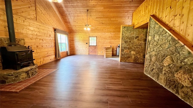 201 Cemetery Rd, Boyd, TX 76023 - unfurnished living room featuring wooden ceiling, dark wood-style flooring, a wood stove, wooden walls, and high vaulted ceiling