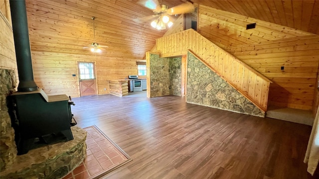 201 Cemetery Rd, Boyd, TX 76023 - unfurnished living room featuring ceiling fan, a wood stove, wooden ceiling, wooden walls, and high vaulted ceiling
