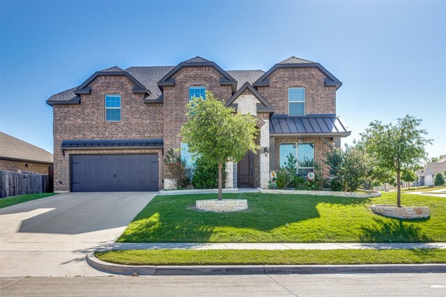 6829 Fire Dance Dr, Benbrook, TX 76126 - view of front of home featuring an attached garage, concrete driveway, brick siding, and a standing seam roof