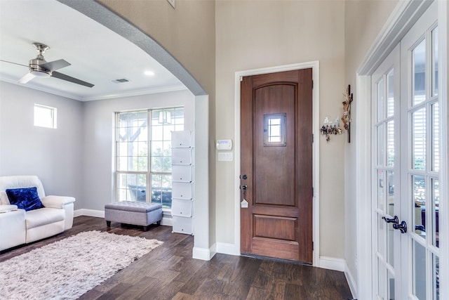 6829 Fire Dance Dr, Benbrook, TX 76126 - foyer entrance with arched walkways, dark wood-style flooring, plenty of natural light, baseboards, and ornamental molding