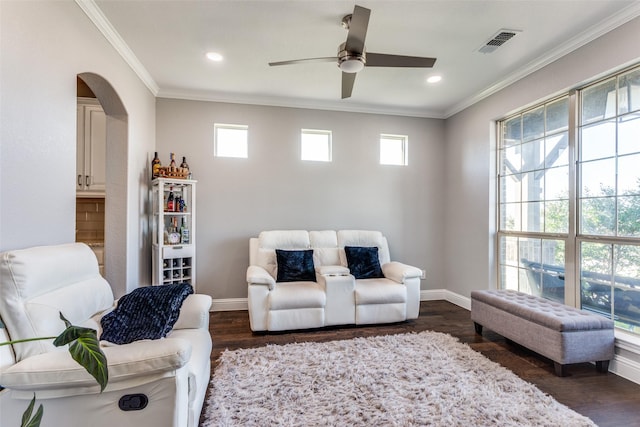 6829 Fire Dance Dr, Benbrook, TX 76126 - living area with crown molding, ceiling fan, dark wood-style floors, baseboards, and arched walkways
