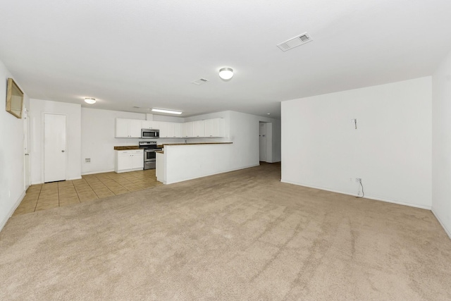 6021 Lucas Ct, Fort Worth, TX 76119 - unfurnished living room featuring light carpet, light tile patterned floors, and baseboards