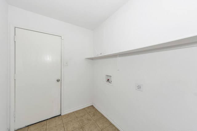 6021 Lucas Ct, Fort Worth, TX 76119 - washroom with hookup for a washing machine, hookup for an electric dryer, baseboards, and light tile patterned floors