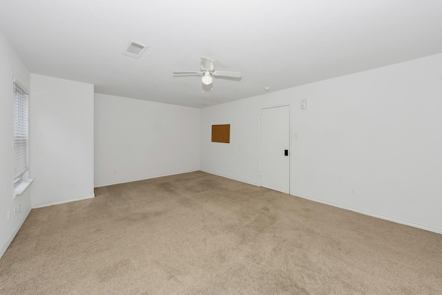 6021 Lucas Ct, Fort Worth, TX 76119 - spare room featuring light colored carpet, a ceiling fan, and baseboards