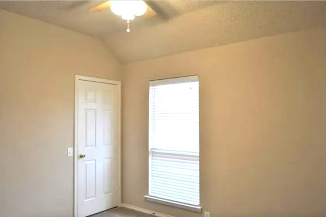 4600 Parkview Ln, Fort Worth, TX 76137 - carpeted empty room with a ceiling fan, vaulted ceiling, and baseboards