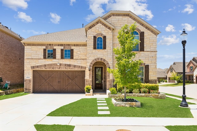 2004 Creekridge Dr, Lewisville, TX 75010 - french country inspired facade with stone siding, driveway, a front lawn, a garage, and brick siding