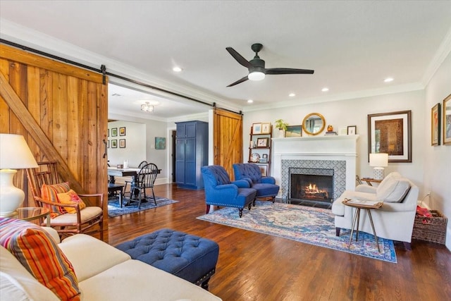 3227 Macarthur Dr, Waco, TX 76708 - living area featuring a barn door, ornamental molding, a ceiling fan, wood finished floors, and recessed lighting