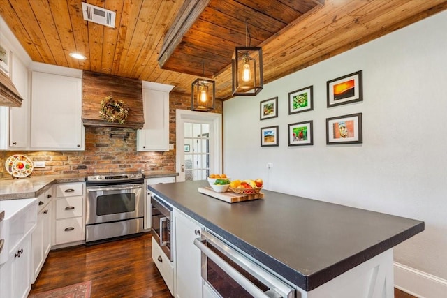 3227 Macarthur Dr, Waco, TX 76708 - kitchen featuring wooden ceiling, appliances with stainless steel finishes, dark countertops, dark wood-type flooring, and white cabinets