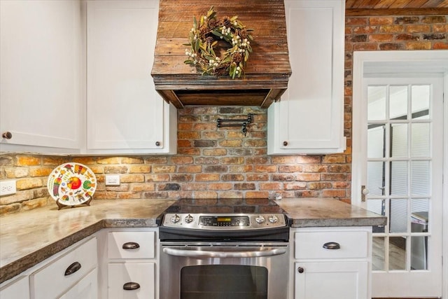3227 Macarthur Dr, Waco, TX 76708 - kitchen featuring electric range, white cabinetry, and tasteful backsplash