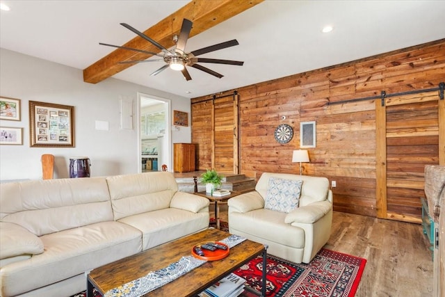 3227 Macarthur Dr, Waco, TX 76708 - living room with a barn door, beam ceiling, wood walls, recessed lighting, and a ceiling fan