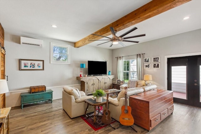 3227 Macarthur Dr, Waco, TX 76708 - living room featuring an AC wall unit, beamed ceiling, a ceiling fan, wood finished floors, and a wainscoted wall