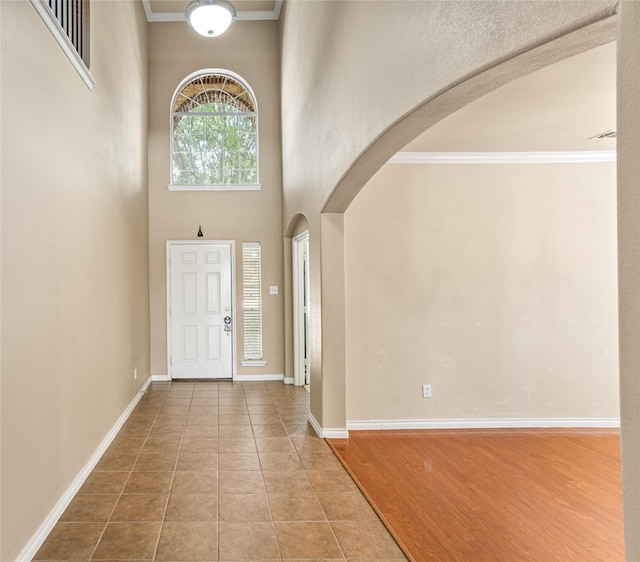 3737 Monica Ln, Fort Worth, TX 76244 - foyer entrance with arched walkways, crown molding, baseboards, a towering ceiling, and tile patterned flooring