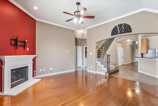 3737 Monica Ln, Fort Worth, TX 76244 - unfurnished living room featuring a ceiling fan, wood finished floors, arched walkways, stairs, and baseboards