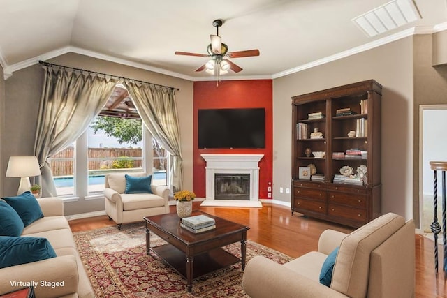 3737 Monica Ln, Fort Worth, TX 76244 - living room with wood finished floors, ceiling fan, a glass covered fireplace, ornamental molding, and baseboards