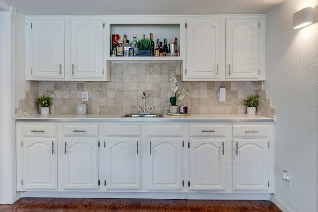 3510 Knoll Point Dr, Garland, TX 75043 - kitchen featuring a sink, white cabinets, backsplash, light countertops, and open shelves
