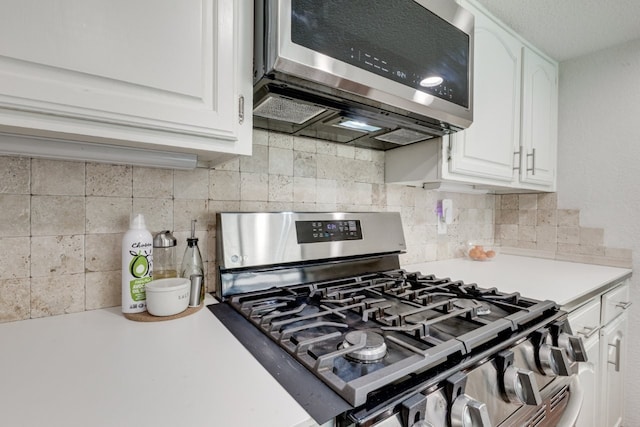 3510 Knoll Point Dr, Garland, TX 75043 - kitchen featuring stainless steel appliances, light countertops, white cabinets, and decorative backsplash