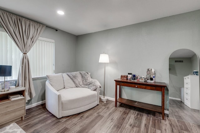 3510 Knoll Point Dr, Garland, TX 75043 - sitting room featuring wood finished floors, arched walkways, baseboards, and recessed lighting