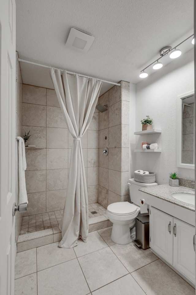 3510 Knoll Point Dr, Garland, TX 75043 - full bathroom with a stall shower, toilet, vanity, tile patterned flooring, and a textured ceiling