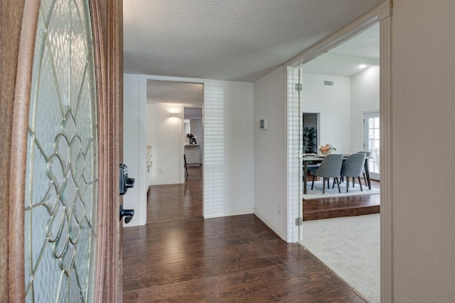 3510 Knoll Point Dr, Garland, TX 75043 - foyer featuring wood finished floors, a textured ceiling, and baseboards