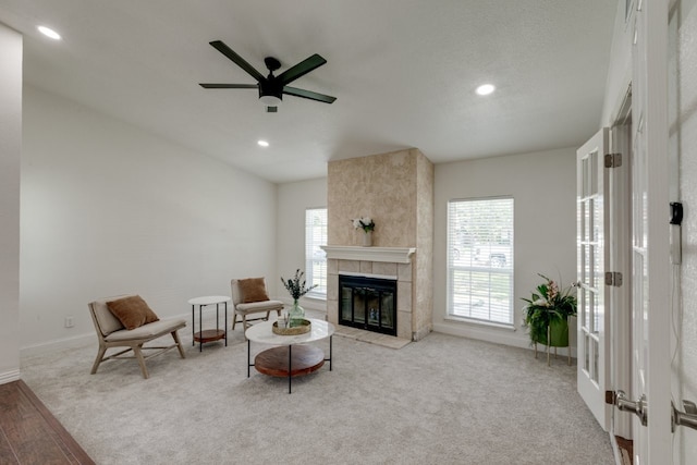 3510 Knoll Point Dr, Garland, TX 75043 - carpeted living room featuring healthy amount of natural light, recessed lighting, a ceiling fan, a tiled fireplace, and baseboards