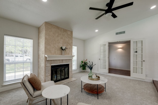 3510 Knoll Point Dr, Garland, TX 75043 - living room with ceiling fan, vaulted ceiling, carpet, recessed lighting, and a tiled fireplace