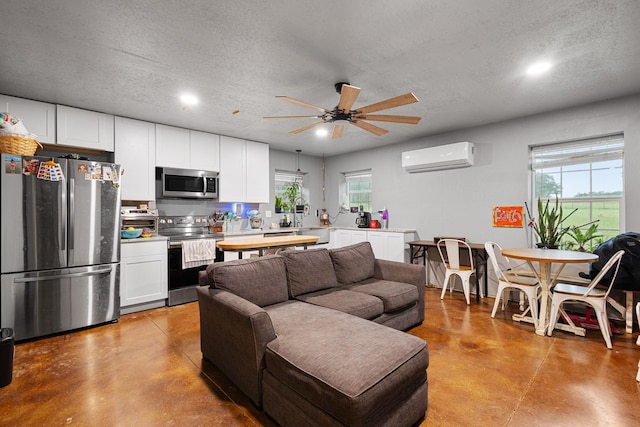 14293 S Fm 372, Valley View, TX 76272 - living room with finished concrete flooring, an AC wall unit, a ceiling fan, a textured ceiling, and recessed lighting