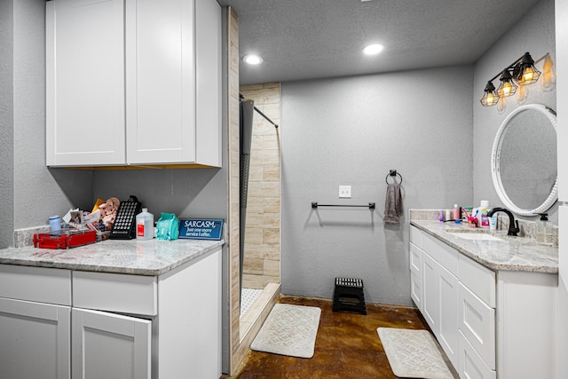 14293 S Fm 372, Valley View, TX 76272 - bathroom featuring vanity, a tile shower, recessed lighting, concrete flooring, and a textured ceiling