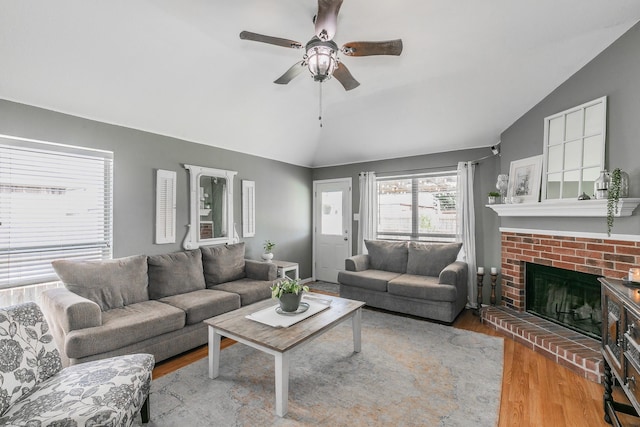 717 Kim Ln, Royse City, TX 75189 - living room with vaulted ceiling, wood finished floors, a ceiling fan, and a brick fireplace