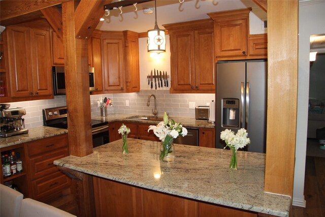 4320 Holland Ave Unit 202, Dallas, TX 75219 - kitchen with stainless steel appliances, a sink, brown cabinets, and tasteful backsplash
