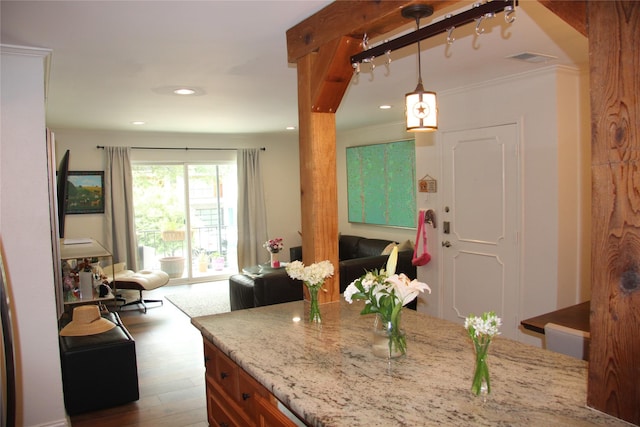 4320 Holland Ave Unit 202, Dallas, TX 75219 - kitchen featuring open floor plan, light stone countertops, dark wood finished floors, decorative light fixtures, and recessed lighting