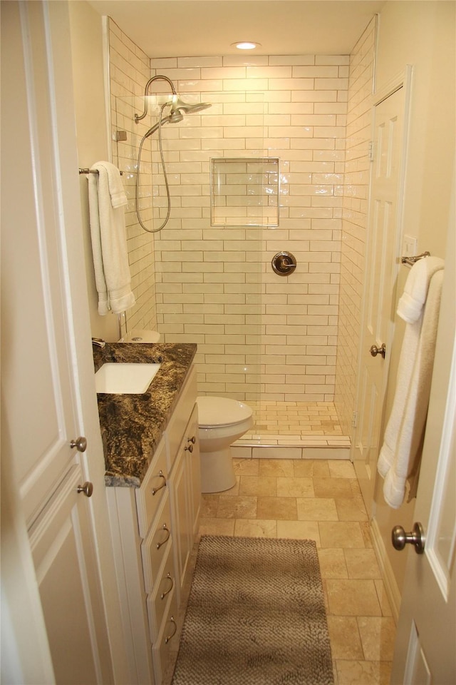 4320 Holland Ave Unit 202, Dallas, TX 75219 - bathroom with a shower stall, toilet, vanity, and stone finish flooring
