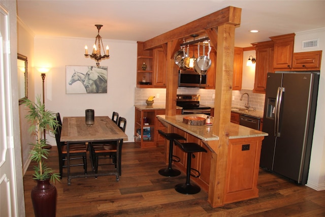 4320 Holland Ave Unit 202, Dallas, TX 75219 - kitchen featuring stainless steel appliances, a chandelier, a sink, decorative backsplash, and ornamental molding
