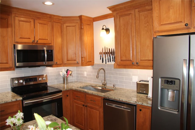4320 Holland Ave Unit 202, Dallas, TX 75219 - kitchen featuring stainless steel appliances, a sink, light stone counters, tasteful backsplash, and recessed lighting
