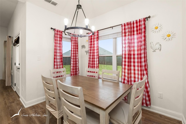 7010 Jet Stream Dr, Abilene, TX 79606 - dining area featuring a chandelier, wood finished floors, and baseboards