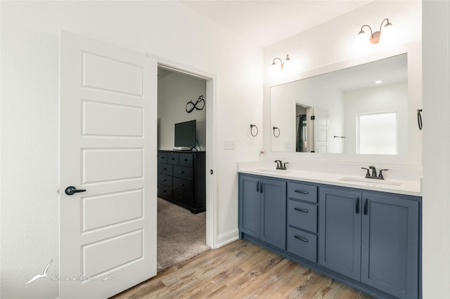 7010 Jet Stream Dr, Abilene, TX 79606 - bathroom featuring wood finished floors and double vanity