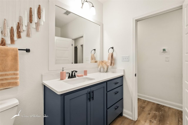 7010 Jet Stream Dr, Abilene, TX 79606 - bathroom featuring vanity, wood finished floors, toilet, and baseboards