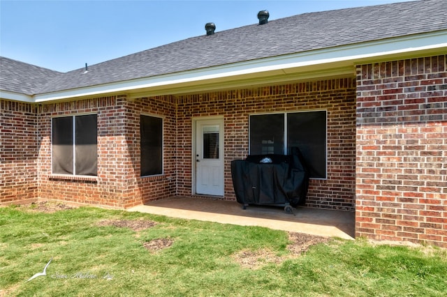 7010 Jet Stream Dr, Abilene, TX 79606 - view of exterior entry featuring brick siding, roof with shingles, and a patio area
