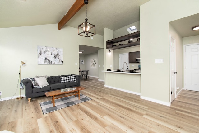 3918 Trinity Dr, Temple, TX 76504 - living area featuring light wood-style floors, a chandelier, and baseboards