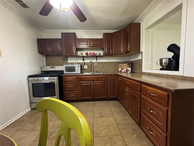 1206 S Crockett Dr, Abilene, TX 79605 - kitchen with stainless steel range with gas cooktop, a sink, white microwave, ceiling fan, and ornamental molding