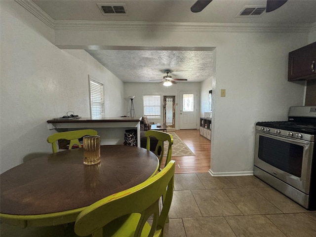 1206 S Crockett Dr, Abilene, TX 79605 - dining room with a ceiling fan, crown molding, tile patterned floors, and baseboards