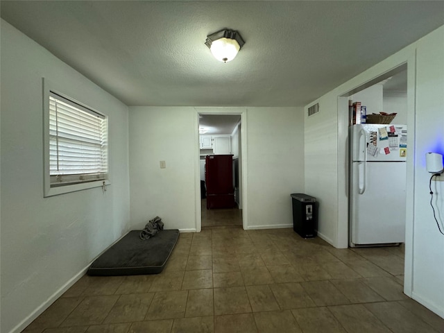 1206 S Crockett Dr, Abilene, TX 79605 - tiled spare room with a textured ceiling and baseboards
