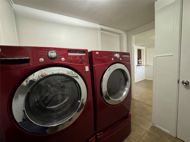 1206 S Crockett Dr, Abilene, TX 79605 - laundry room featuring separate washer and dryer, tile patterned flooring, and a textured ceiling