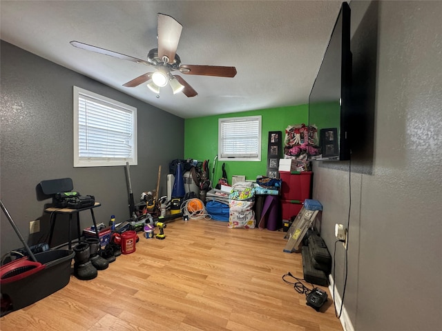 1206 S Crockett Dr, Abilene, TX 79605 - playroom featuring wood finished floors, healthy amount of natural light, a textured wall, and a ceiling fan