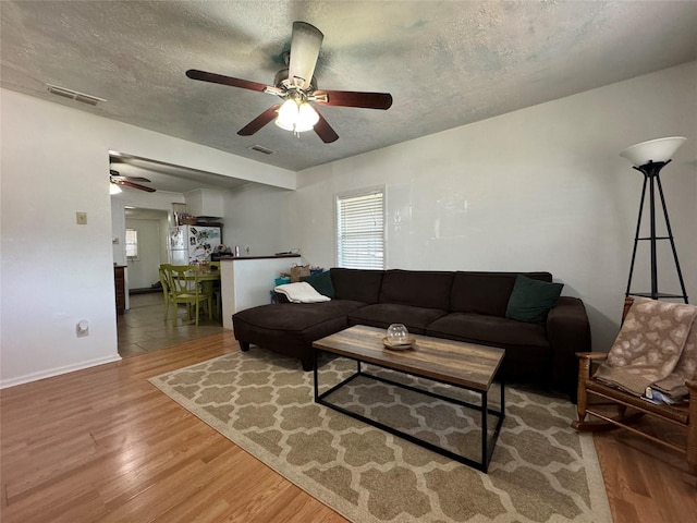 1206 S Crockett Dr, Abilene, TX 79605 - living room featuring ceiling fan, wood finished floors, and a textured ceiling