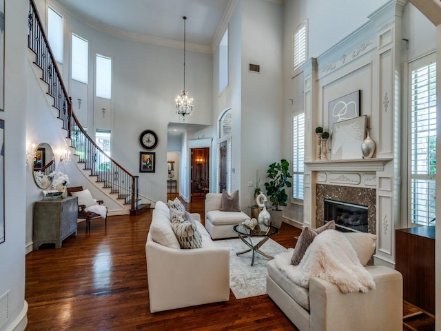 6609 Riverhill Dr, Plano, TX 75024 - living room with a fireplace, stairs, dark wood-style floors, ornamental molding, and a high ceiling