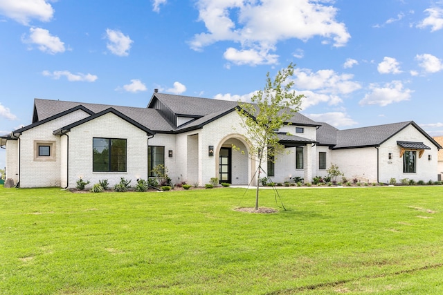 1324 Streetman Rd, Royse City, TX 75189 - view of front of house with brick siding, a front yard, and roof with shingles