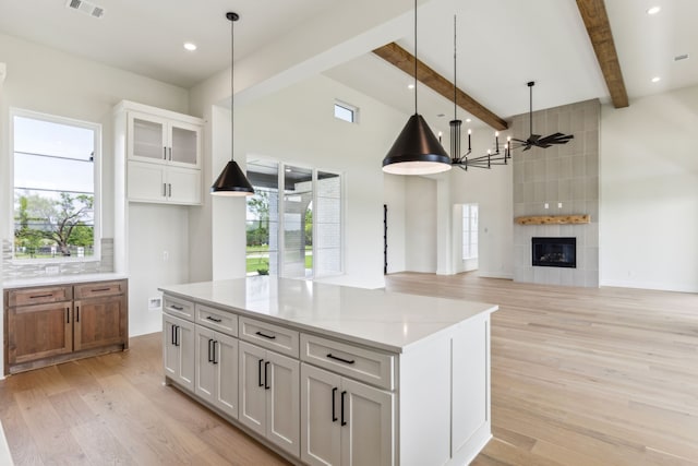 1324 Streetman Rd, Royse City, TX 75189 - kitchen with light wood-style floors, white cabinets, beam ceiling, healthy amount of natural light, and pendant lighting